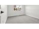Bright bedroom with carpeted floors, a large window and neutral paint at 4102 W Union Ave, Denver, CO 80236