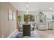 Modern dining room features a glass table, stylish chairs, and a beautiful accent wall at 4102 W Union Ave, Denver, CO 80236