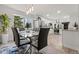 Contemporary dining area with a glass table, modern chairs, and stainless steel appliances at 4102 W Union Ave, Denver, CO 80236