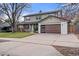 Attractive home features a modern garage door, covered porch, and well-manicured lawn at 4102 W Union Ave, Denver, CO 80236