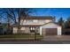 Charming two-story home featuring a modern garage door, covered porch, and fresh landscaping at 4102 W Union Ave, Denver, CO 80236