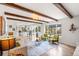 Bright living room with exposed beams, contemporary decor, and access to the deck at 4102 W Union Ave, Denver, CO 80236