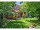 Lush backyard featuring a well-maintained lawn, a patio area with seating, and mature trees for added privacy at 4258 Tennyson St # 101, Denver, CO 80212