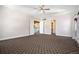 Expansive bedroom with neutral tones, a ceiling fan, and convenient access to closet and hallway at 4258 Tennyson St # 101, Denver, CO 80212