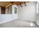 An empty room featuring a patterned wall, exposed wood ceiling beams, and two windows providing natural light at 4258 Tennyson St # 101, Denver, CO 80212