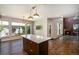 Bright open kitchen featuring a large island, hardwood floors, and stainless steel appliances at 4258 Tennyson St # 101, Denver, CO 80212