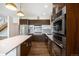 Modern kitchen with stainless steel appliances, quartz countertops, and a large center island at 4258 Tennyson St # 101, Denver, CO 80212