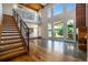 Open-concept living space with high ceilings, a modern staircase, and a fireplace at 4258 Tennyson St # 101, Denver, CO 80212