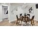 Basement dining room features a modern glass table, four chairs, and an area rug at 4844 Vallejo St, Denver, CO 80221