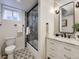 Finished basement bathroom features patterned floors, glass shower door, and a modern vanity at 4844 Vallejo St, Denver, CO 80221