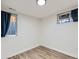 Finished basement bedroom features a window, wood-look floors, and simple decorations at 4844 Vallejo St, Denver, CO 80221