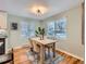 Bright dining room featuring hardwood floors, large windows, and a modern light fixture at 4844 Vallejo St, Denver, CO 80221