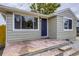 Charming home features a front porch with stone details, complemented by large windows and classic design at 4844 Vallejo St, Denver, CO 80221