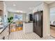 Open concept kitchen and dining area with stainless steel appliances and modern finishes at 4844 Vallejo St, Denver, CO 80221