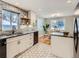 Modern kitchen with stainless steel appliances, and white cabinets, adjacent to the dining area at 4844 Vallejo St, Denver, CO 80221