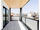 Spacious outdoor balcony with glass railings, modern tile flooring and neighborhood views at 421 S Pearl St, Denver, CO 80209