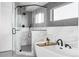 Contemporary bathroom showcasing a glass-enclosed shower, a luxurious soaking tub, and elegant marble and gray tiling at 421 S Pearl St, Denver, CO 80209