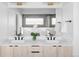 Modern bathroom featuring double sinks, a sleek countertop, and a large mirror reflecting a luxurious shower and tub at 421 S Pearl St, Denver, CO 80209