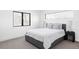 Bright bedroom featuring a gray bed, large windows, neutral walls, and modern decor at 421 S Pearl St, Denver, CO 80209