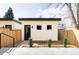 Modern home featuring minimalist design, small windows, light colored walls, and a well-manicured front yard at 421 S Pearl St, Denver, CO 80209