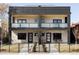 Modern exterior of a townhome with brick facade, black trim, and frosted glass balconies at 421 S Pearl St, Denver, CO 80209