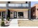 Modern townhome with brick facade, black trim, and outdoor seating on the front porch at 421 S Pearl St, Denver, CO 80209