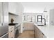 Modern kitchen with large island, stylish pendants, white cabinetry, and stainless appliances at 421 S Pearl St, Denver, CO 80209