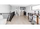 Modern living room features bar with a wine fridge, bar stools, and stairs with black railings at 421 S Pearl St, Denver, CO 80209