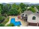 A charming pool and hot tub with a cozy deck, complemented by lush landscaping and mountain views at 8160 W Phillips W Ave, Littleton, CO 80128