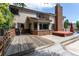 Spacious backyard featuring a wooden deck, hot tub, and brick chimney for outdoor relaxation at 8160 W Phillips W Ave, Littleton, CO 80128
