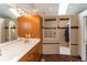 Bright bathroom showcasing a double vanity, cabinets, and multi-head shower with a glass enclosure at 8160 W Phillips Ave, Littleton, CO 80128