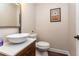 Half bathroom with modern vessel sink and vanity, adjacent to the living area at 8160 W Phillips W Ave, Littleton, CO 80128