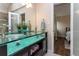 Bathroom featuring unique glass vessel sinks and a vanity with ample storage space at 8160 W Phillips W Ave, Littleton, CO 80128