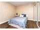 Comfortable bedroom showcases wood floors, sliding mirror closet doors, and bright natural light at 8160 W Phillips W Ave, Littleton, CO 80128