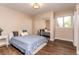 Cozy bedroom features wood floors, natural light from the window, and a closet with sliding mirror doors at 8160 W Phillips W Ave, Littleton, CO 80128