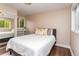 Well-lit bedroom features wood floors and natural light with a window and mirror door closet at 8160 W Phillips W Ave, Littleton, CO 80128