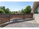 Outdoor deck with decorative outdoor rug and views of backyard pool and mature trees at 8160 W Phillips W Ave, Littleton, CO 80128