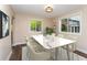 Bright dining area with large windows and a stylish table that comfortably seats six at 8160 W Phillips Ave, Littleton, CO 80128