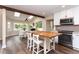Bright kitchen featuring an island with seating, stainless appliances, and adjacent breakfast area at 8160 W Phillips W Ave, Littleton, CO 80128