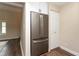 Kitchen area featuring a stainless steel refrigerator and a white pantry door at 8160 W Phillips Ave, Littleton, CO 80128