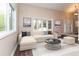 Bright living room featuring a large window, neutral color palette, and hardwood floors at 8160 W Phillips Ave, Littleton, CO 80128