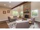 Cozy living room featuring a brick fireplace, a vaulted ceiling and comfortable modern furniture at 8160 W Phillips W Ave, Littleton, CO 80128