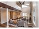 Bright living room boasts high ceilings, brick fireplace, and stylish neutral-toned furniture at 8160 W Phillips W Ave, Littleton, CO 80128