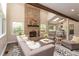 Comfortable living room has a brick fireplace, lots of light and elegant gray furniture at 8160 W Phillips W Ave, Littleton, CO 80128