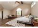Spacious main bedroom boasts vaulted ceiling, ceiling fan, large window, and cozy sitting area at 8160 W Phillips W Ave, Littleton, CO 80128