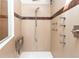Modern shower features multiple shower heads, a built-in seat, and neutral-toned tile at 8160 W Phillips W Ave, Littleton, CO 80128