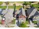 Aerial view of a red two-story home with a well-maintained backyard and a gray shingle roof at 10778 Dayton Way, Commerce City, CO 80640