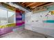 View of an unfinished basement with bare wood ceiling and moisture barrier on walls at 10778 Dayton Way, Commerce City, CO 80640