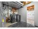 Unfinished basement with washer and dryer and storage shelves at 10778 Dayton Way, Commerce City, CO 80640