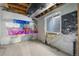 Unfinished basement with exposed ceiling, concrete flooring, and moisture barrier at 10778 Dayton Way, Commerce City, CO 80640